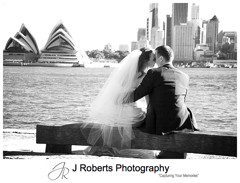Sillhouette of couple leaning together with Sydney Opera House behind - wedding photography sydney